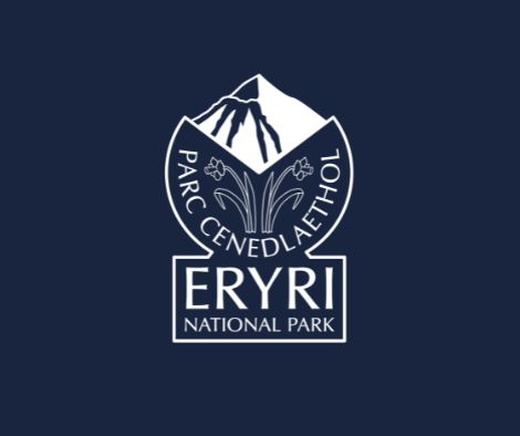 Logo of Eryri National Park featuring an illustration of a mountain in the background and two daffodils facing opposite directions. The logo is bilingual, displaying both English and Welsh text.